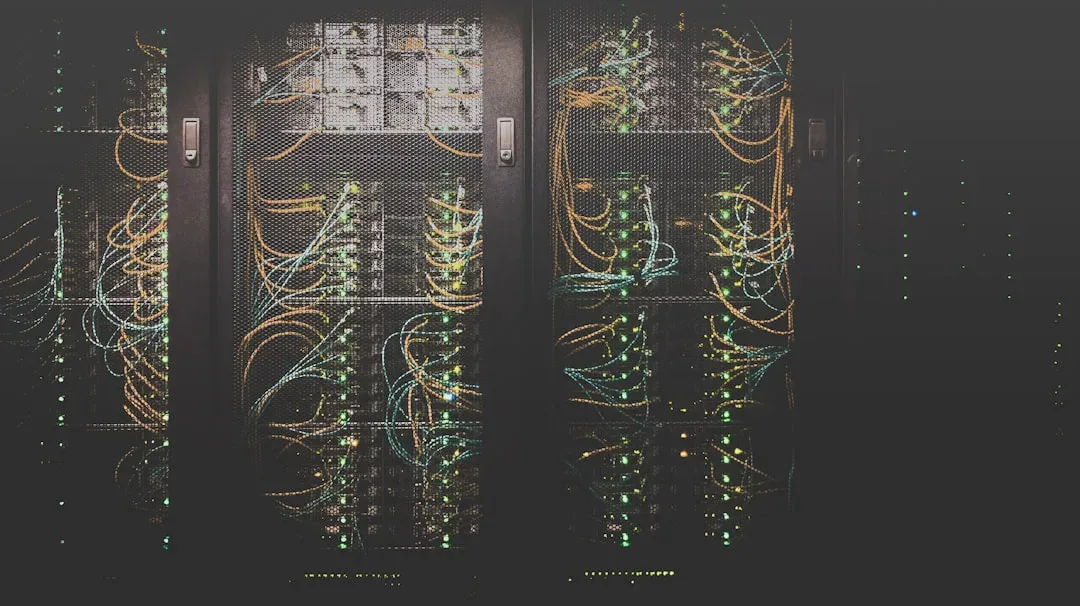 The photo shows a server room with numerous server racks, lit by colorful LEDs and cabling. The setting points to a technologically advanced environment associated with data centers and IT infrastructure. - Photo: Taylor Vick